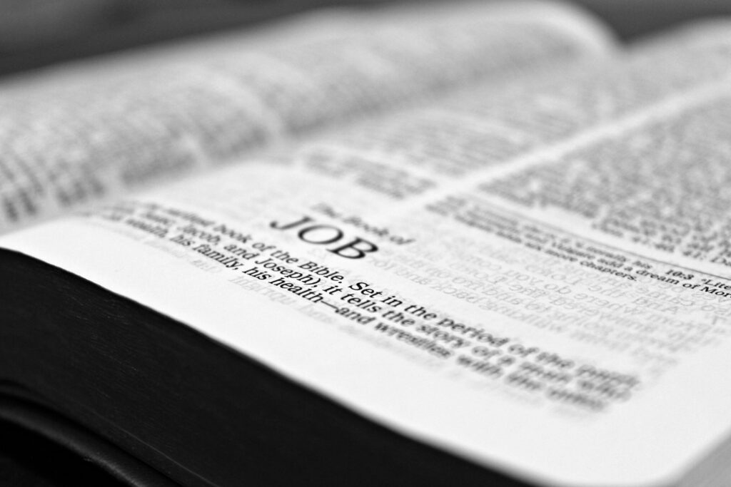 bible-job-reading-christianity-159679-159679 Close-up black and white image focusing on a Bible page with the Book of Job.