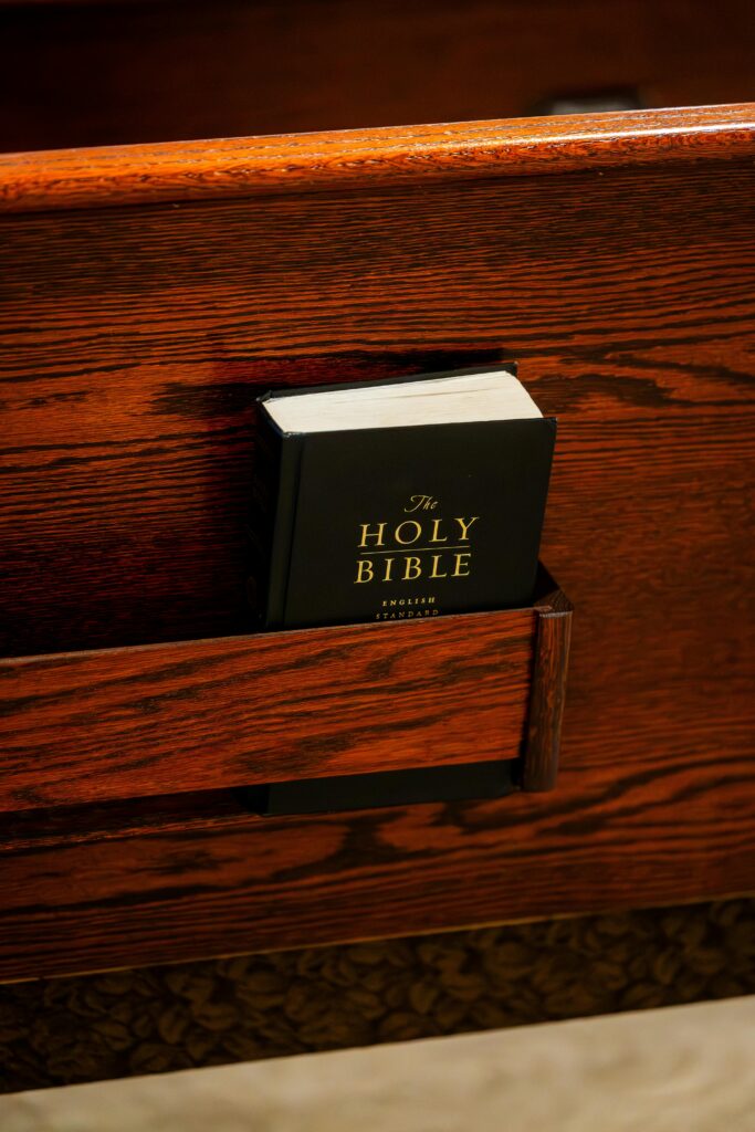 pexels-photo-34680724-34680724 A Holy Bible resting in a church pew holder, symbolizing faith and spirituality.